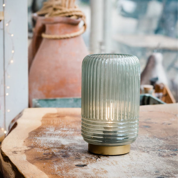 Cordless ribbed table lamp on window sill