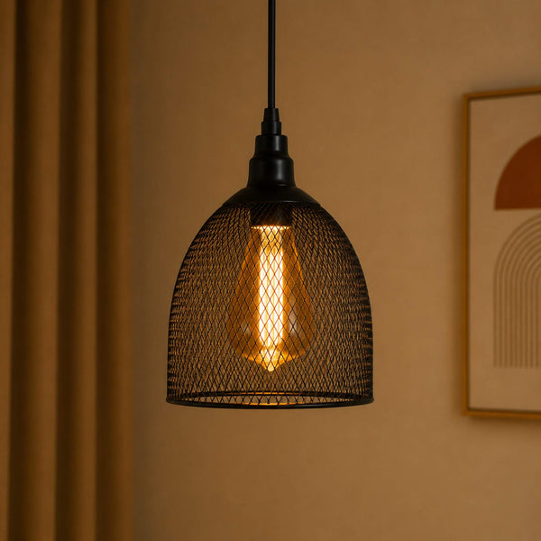 Black wire mesh pendant light hanging against a beige wall with a framed picture.