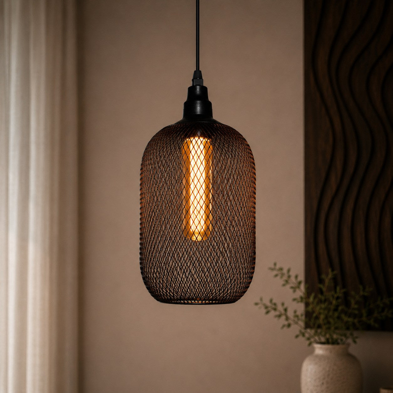 Decorative pendant light with mesh design hanging against a neutral wall.