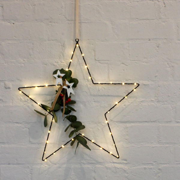 black Star Light hanging with festive decoration 