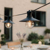 Industrial outdoor festoon lights with black shades and Edison-style bulbs for modern garden decor.
